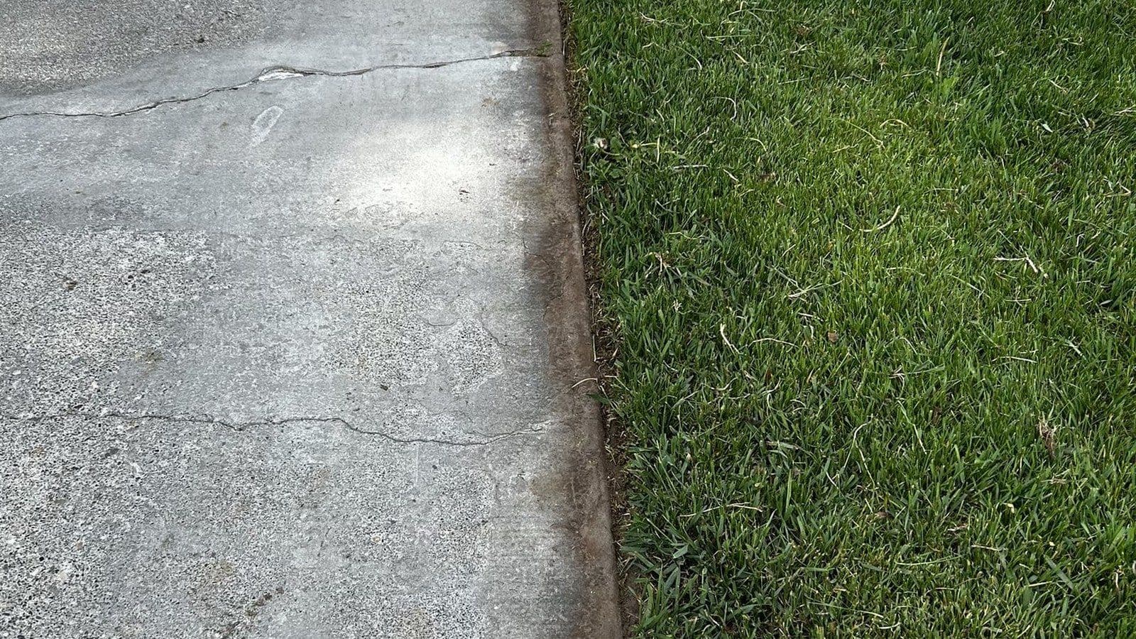 After: fresh vertical edge cut, debris blown off — Young Buck Lawn Care