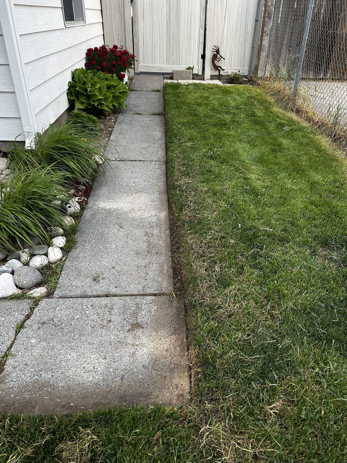 Rexburg, ID — Stripe-cut lawn around a tree in Rexburg, Idaho — Young Buck Lawn Care