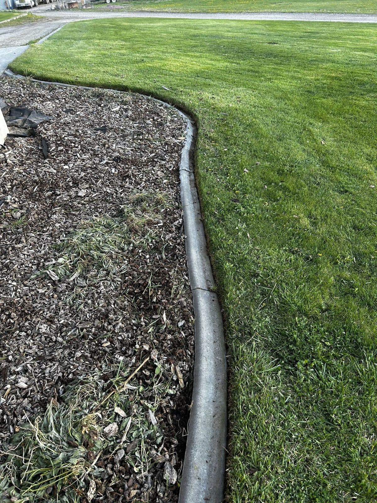 Clean grass edge along concrete after lawn edging — Young Buck Lawn Care, Rexburg, Idaho